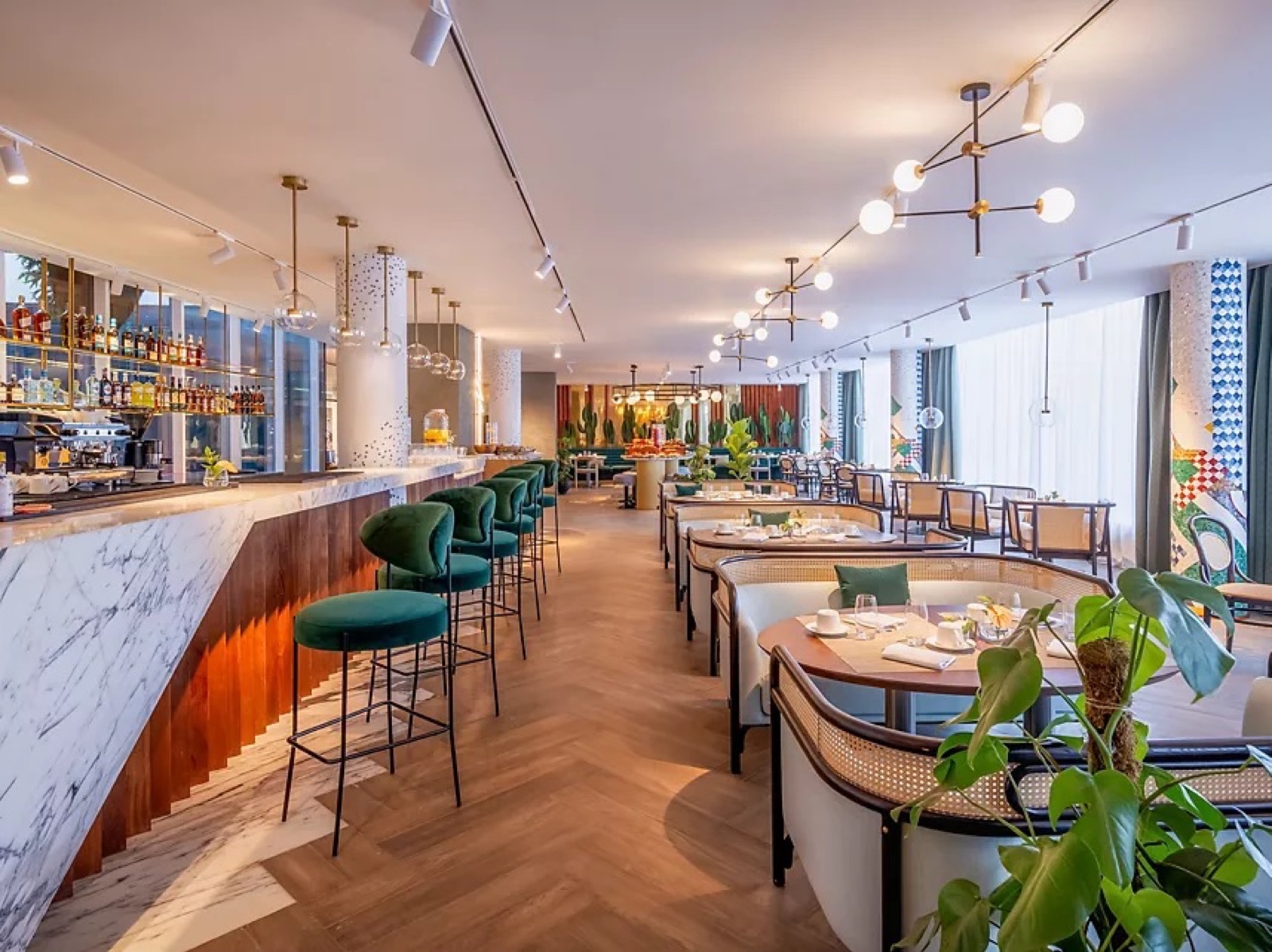 Marble bar counter with green stools in the Gem Forest restaurant