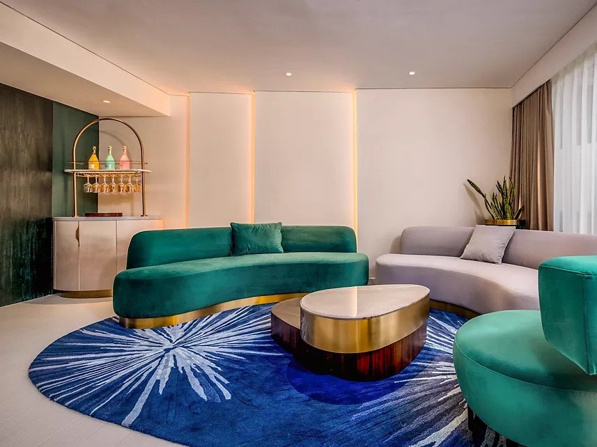 Lounge seating and drinks cabinet in a Gem Forest suite