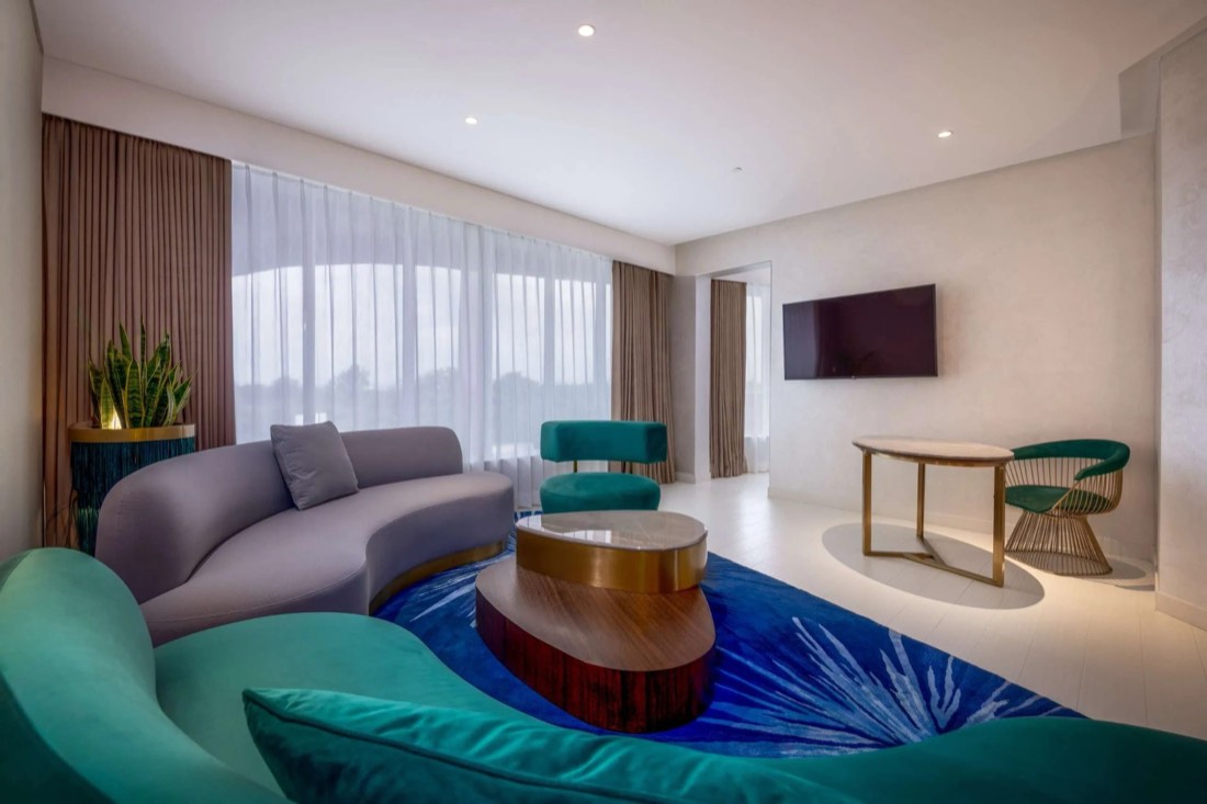 Suite living room with curved sofas at Gem Forest