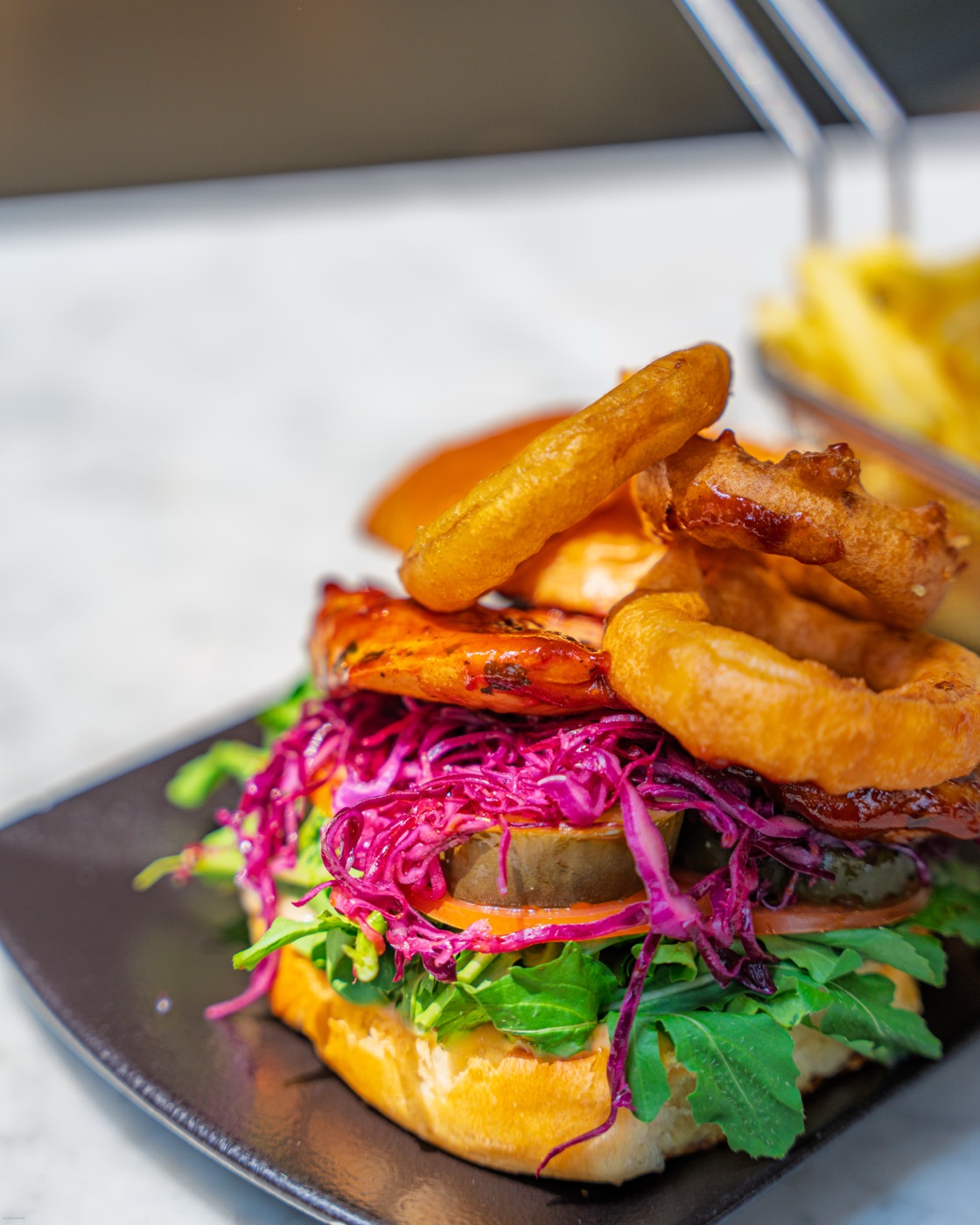 Burger with onion rings and red cabbage
