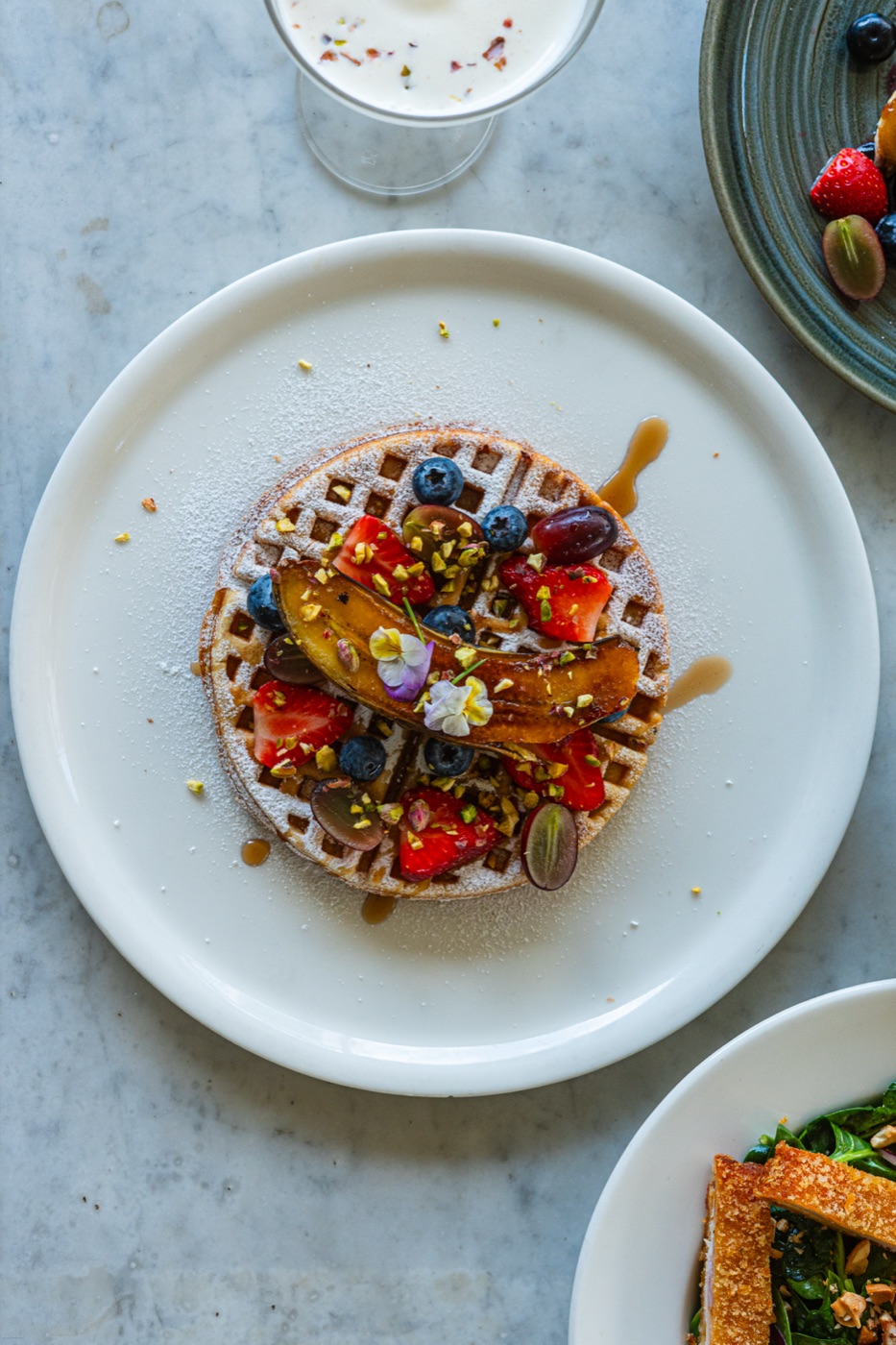Waffle topped with fruit and flowers