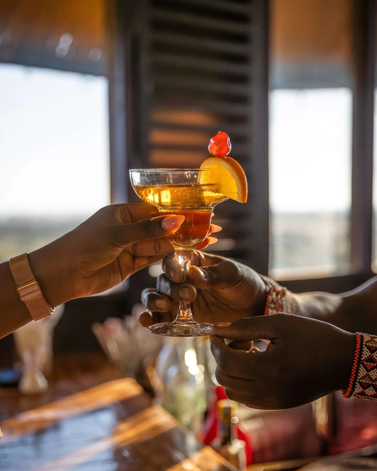 Cocktails being passed across the bar