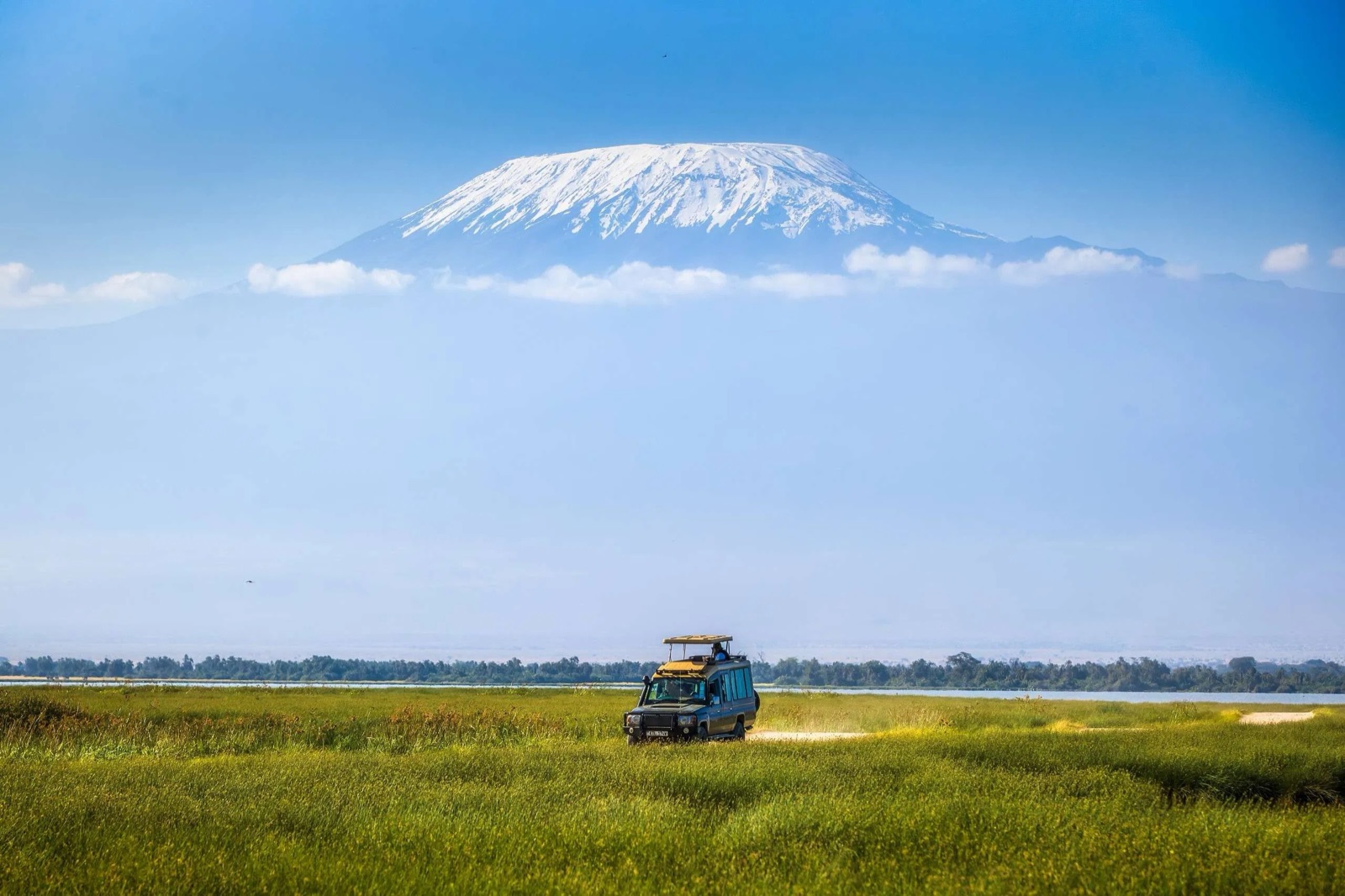 Safari vehicle on the plains below Kilimanjaro